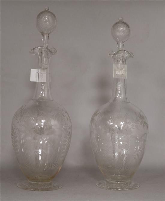 A pair of etched glass decanters